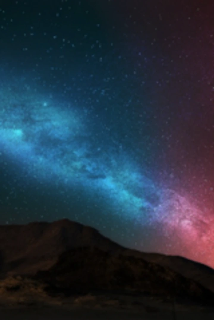 Milky Way stretching over a dark mountain range